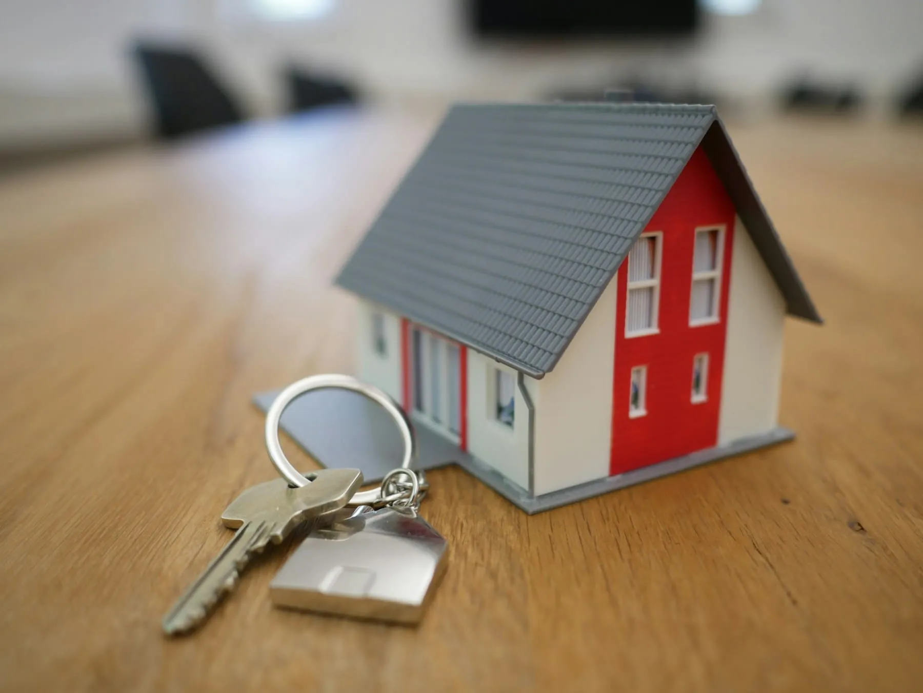 A real estate agent handing house keys to new homeowners
